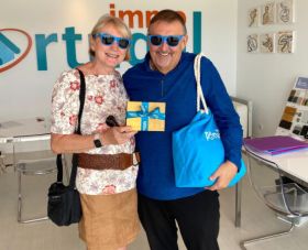 Immo Portugal clients at the office receiving promotional gift and their Simple Life Membership card