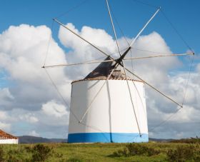 Traditional windmill painted blue and white in the countryside of Silver Coast Portugal